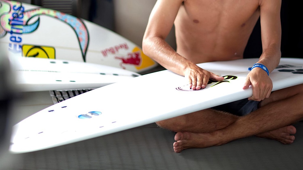 How often should I remove wax from my surfboard
